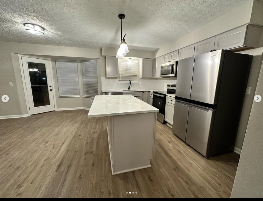 New cabinetry, quartz island and LVP flooring
